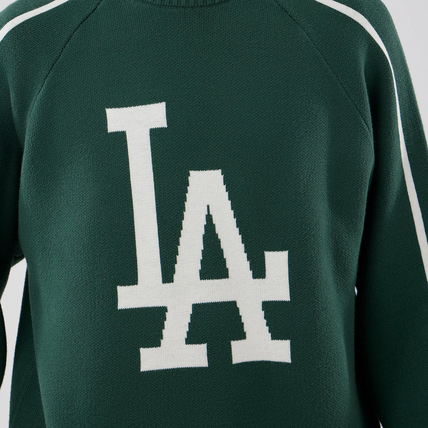 The model is wearing this MLB Knit LA Dodgers Knitted Sweater in dark green. 4