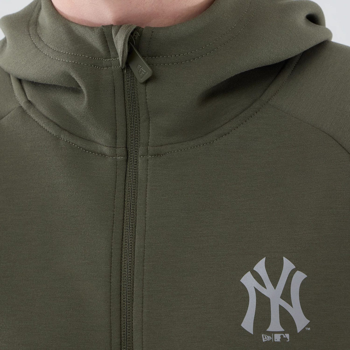 New Era New York Yankees MLB Core Plus Green Full Zip Hoodie, front view showcasing a green hoodie with a central zip running down the front, a raised New York Yankees logo printed in white on the left chest, and a fitted hood at the top.