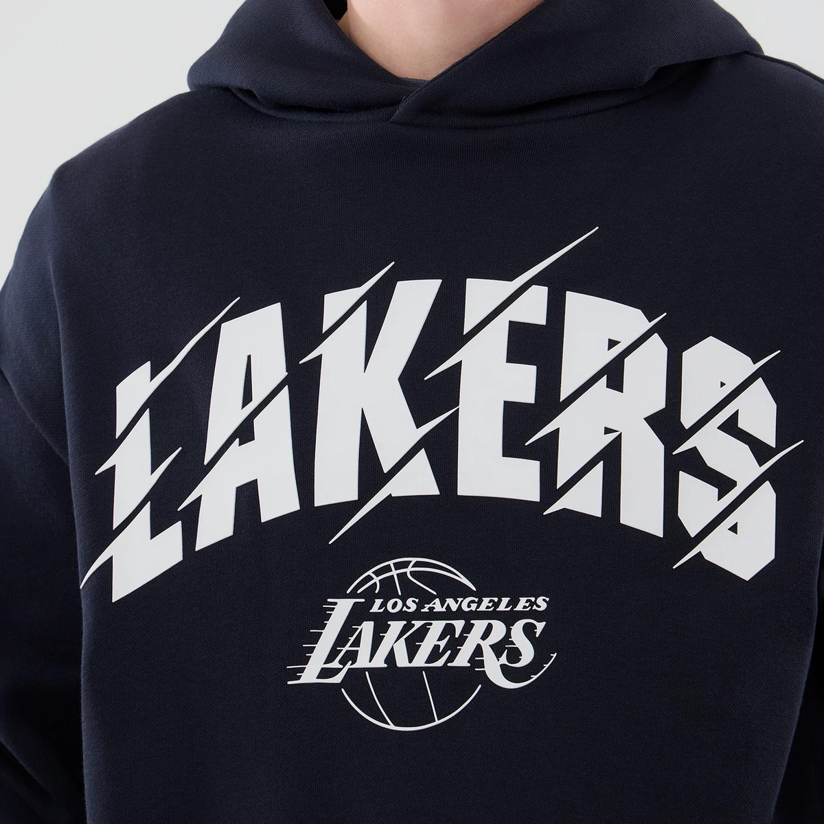 New Era LA Lakers NBA Core Plus Navy Pullover Hoodie, front view showcasing the white LAKERS lettering with diagonal slashes across the chest, and the detailed LOS ANGELES LAKERS printed logo featuring a basketball design below the main text.