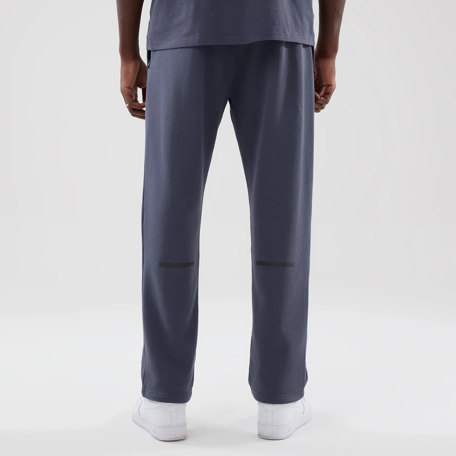 The model is wearing these New Era Tech Straight Leg Joggers in grey. 2