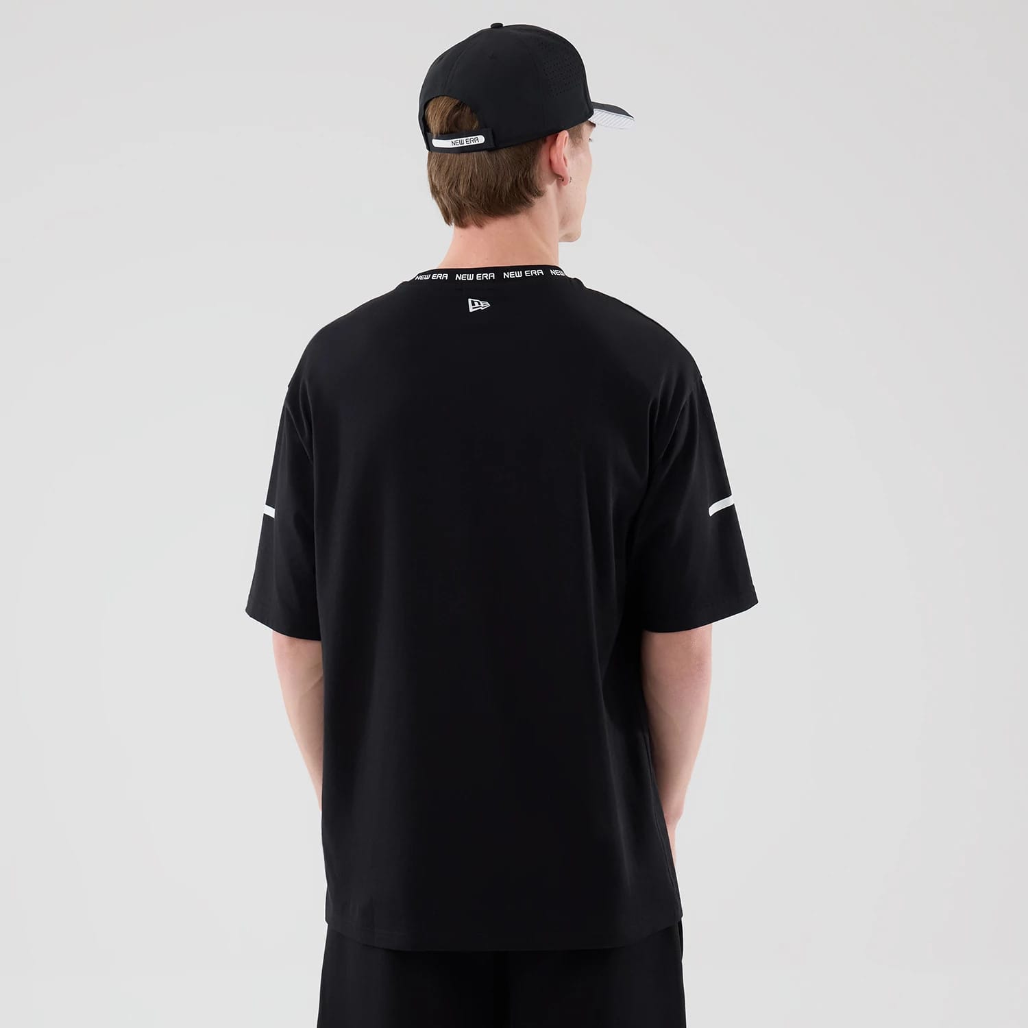 The model is wearing this New Era Tech T-Shirt in black. 2