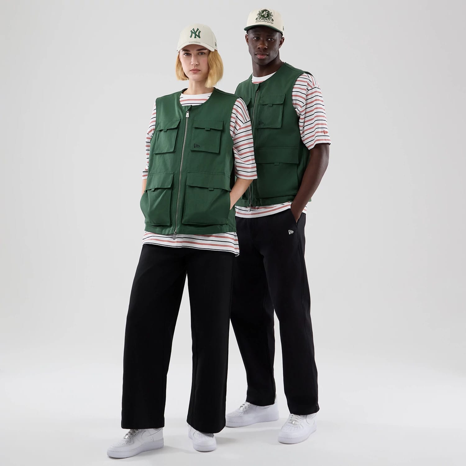 The model is wearing this New Era Utility Vest in dark green. 1