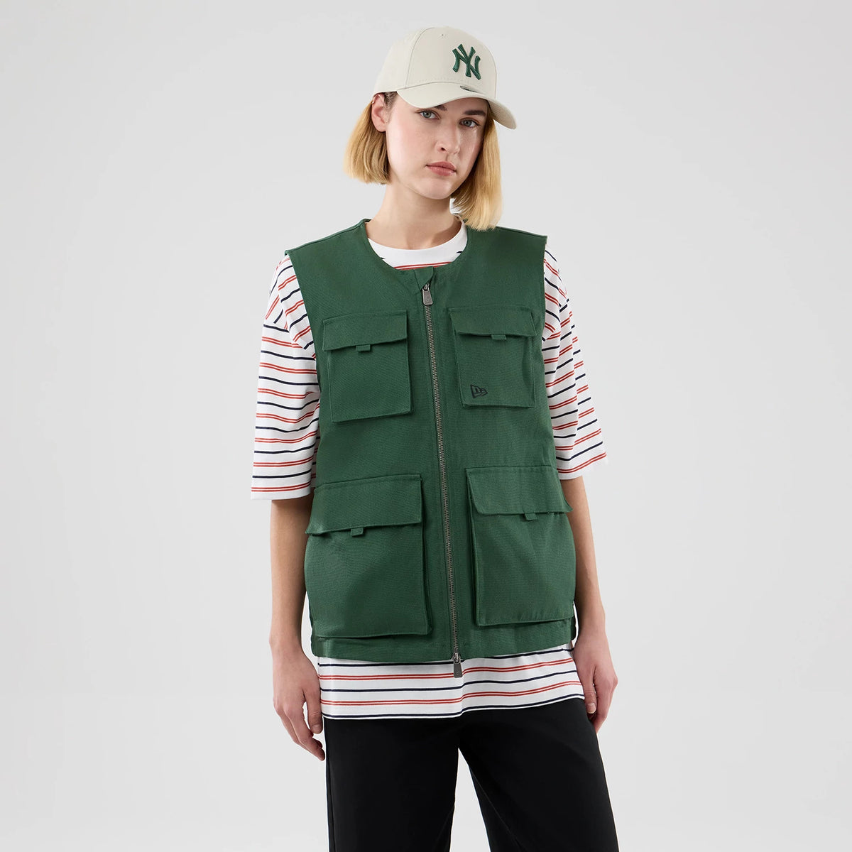 The model is wearing this New Era Utility Vest in dark green. 4