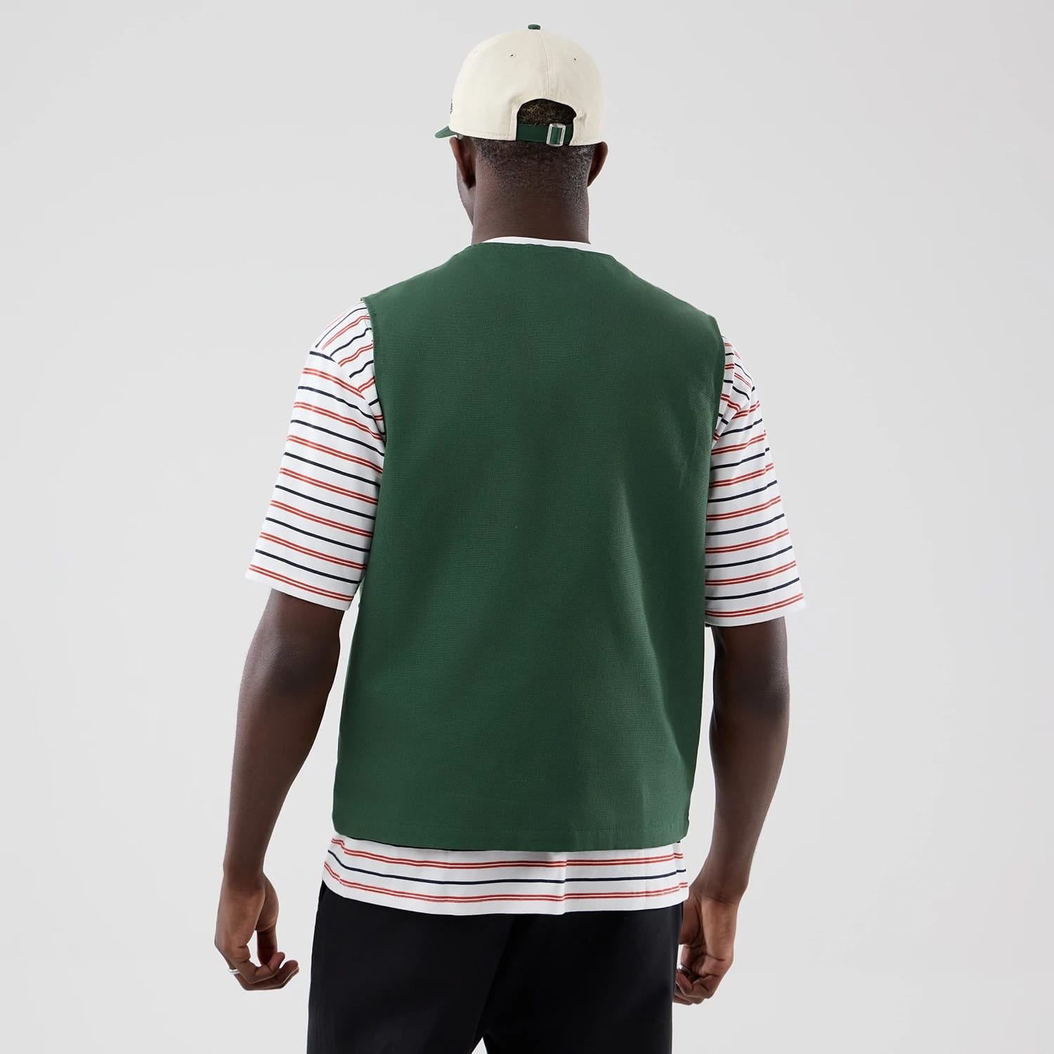 The model is wearing this New Era Utility Vest in dark green. 2