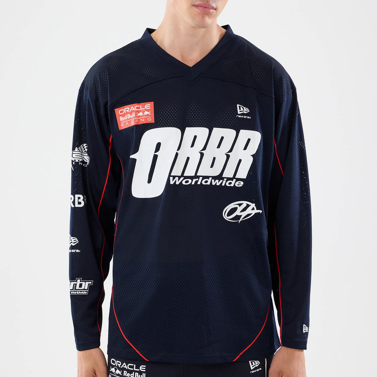 New Era Red Bull Racing Dark Blue Hockey Jersey, front view on a model showing the large white ORBR Worldwide lettering across the chest, with the Oracle Red Bull Racing patch and New Era flag logo on the upper right side.