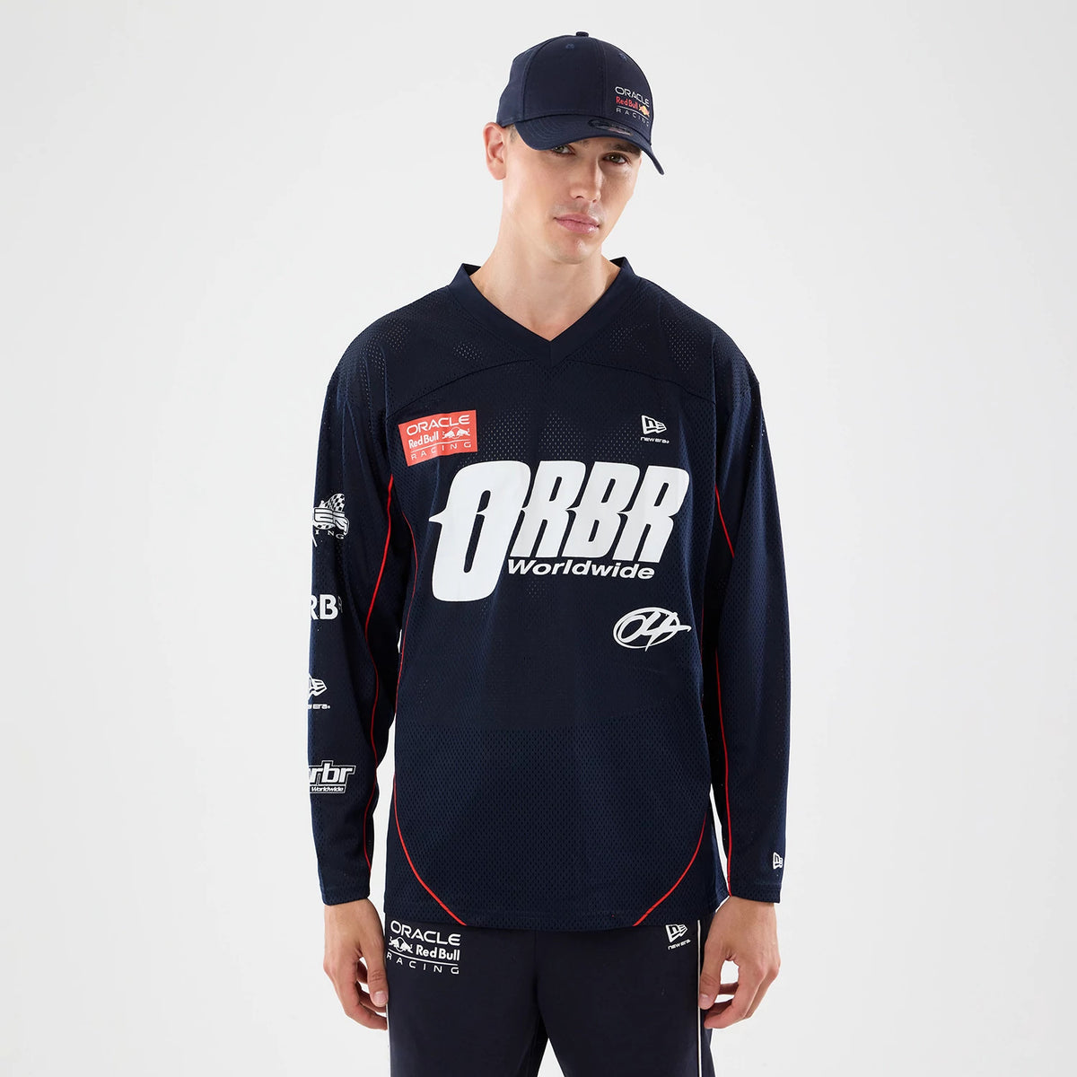 New Era Red Bull Racing Dark Blue Hockey Jersey, front view on a model styled with a dark blue cap, featuring the ORBR Worldwide logo emblazoned in white across the chest and multiple sponsorship patches on both sleeves.