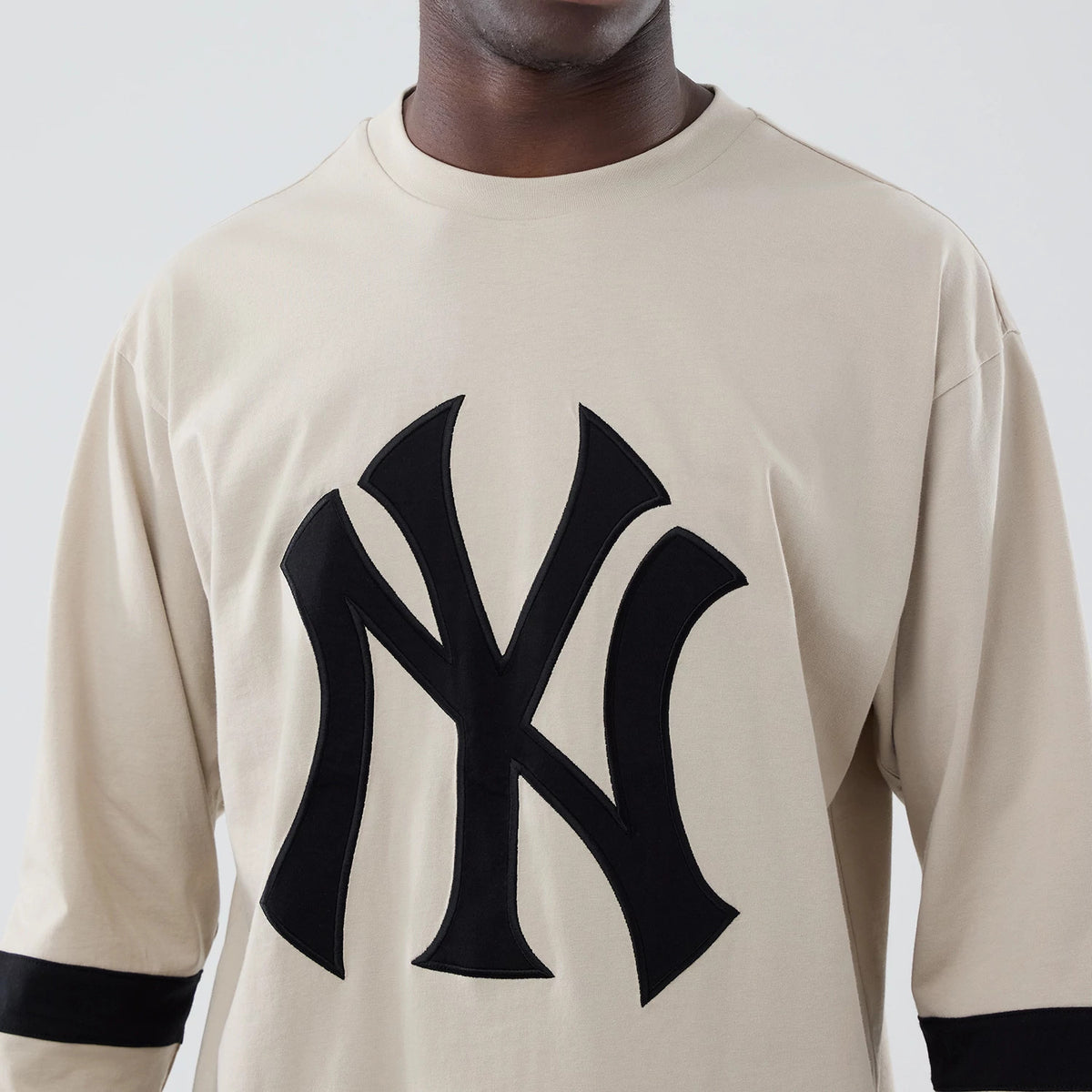 The model is wearing this MLB New York Yankees Oversized Long Sleeve T-Shirt in light beige. 4