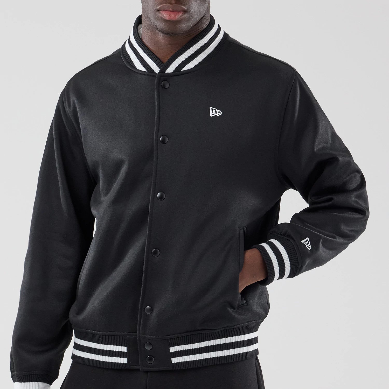 The model is wearing this New Era Jersey Bomber Jacket in black. 3