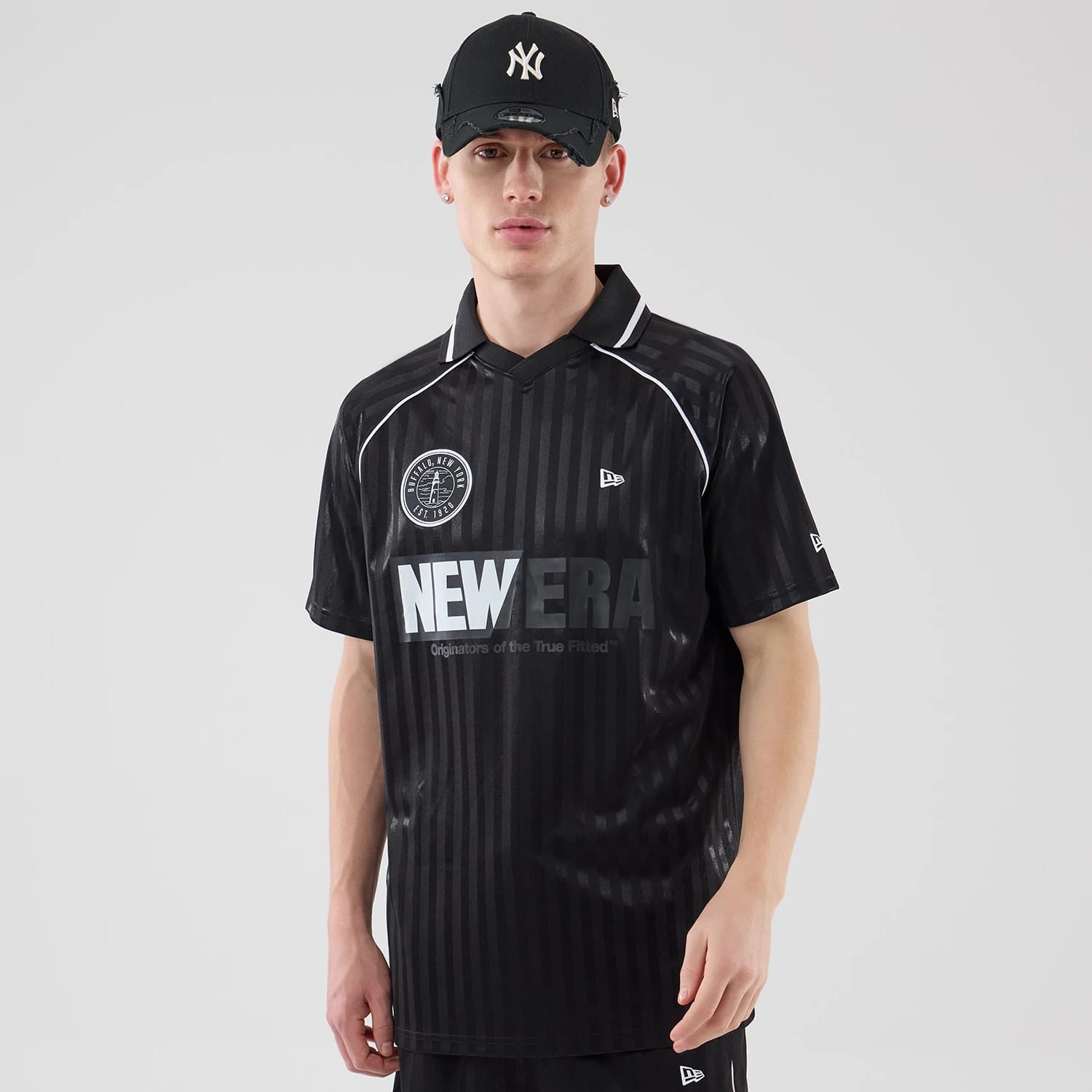 The model is wearing this New Era Football Jersey T-Shirt in black. 1