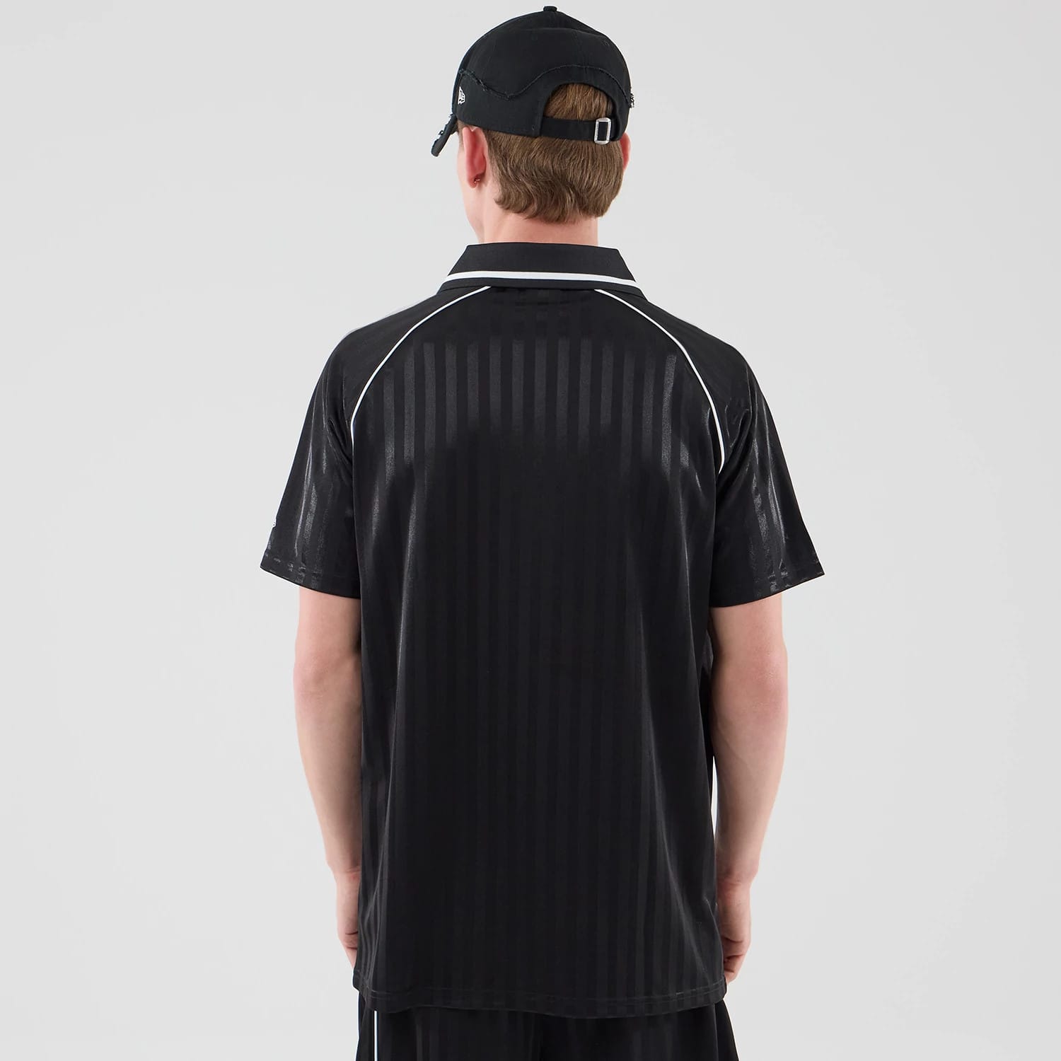 The model is wearing this New Era Football Jersey T-Shirt in black. 2