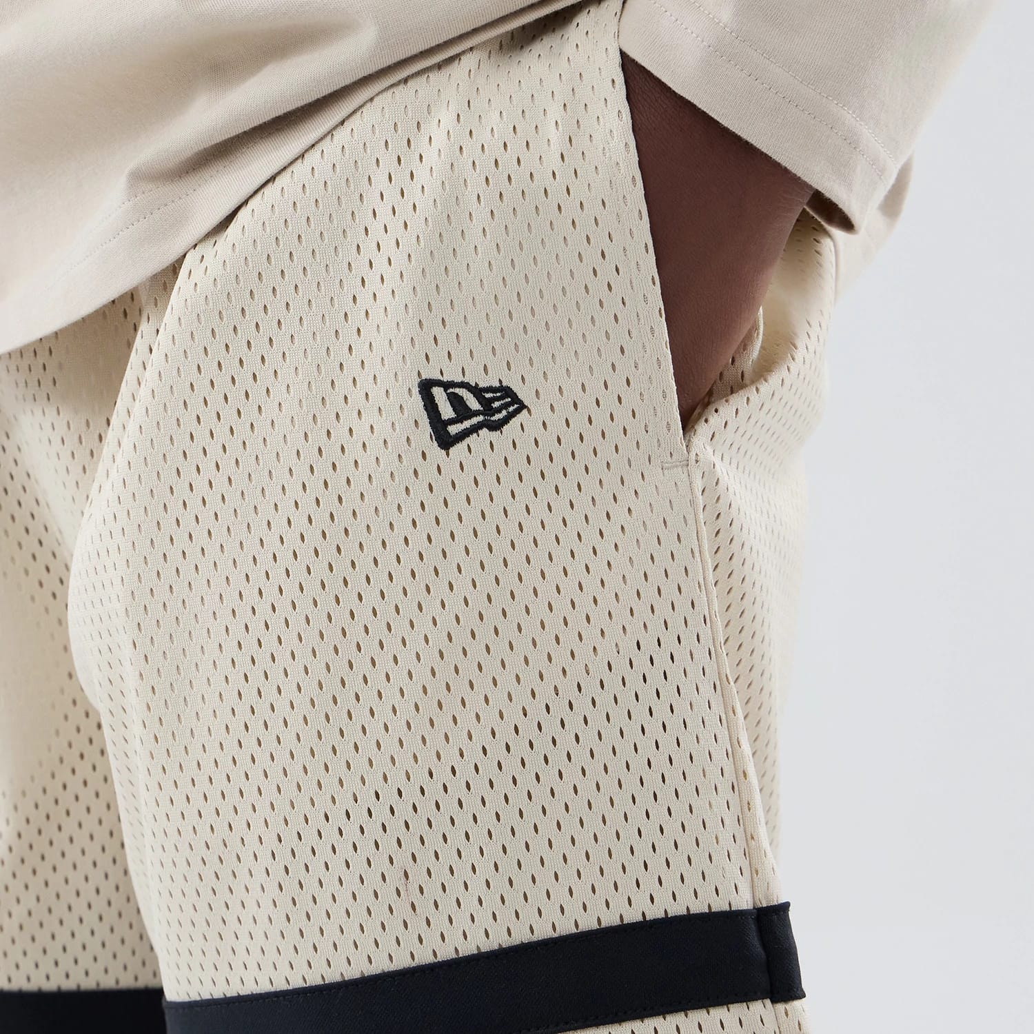 The model is wearing these MLB New York Yankees Oversized Mesh Shorts in light beige. 4