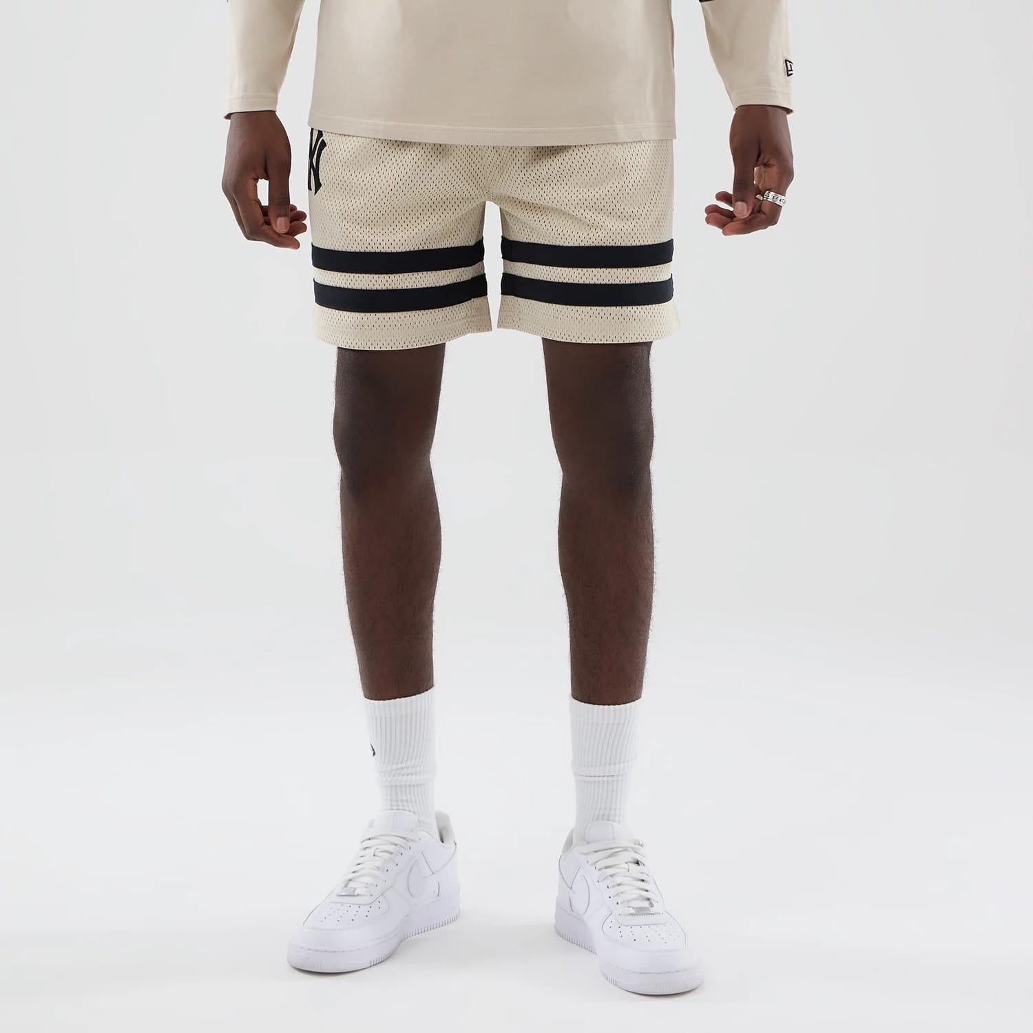 The model is wearing these MLB New York Yankees Oversized Mesh Shorts in light beige. 1