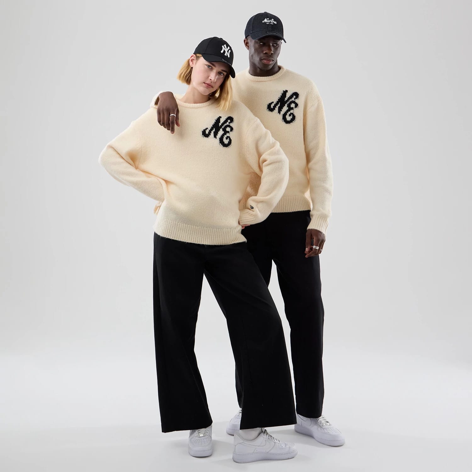 The model is wearing this New Era Knit Knitted Sweater in cream. 1