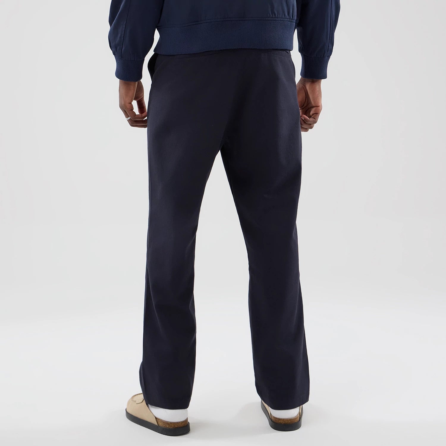 The model is wearing these New Era Chino Trousers in navy. 2