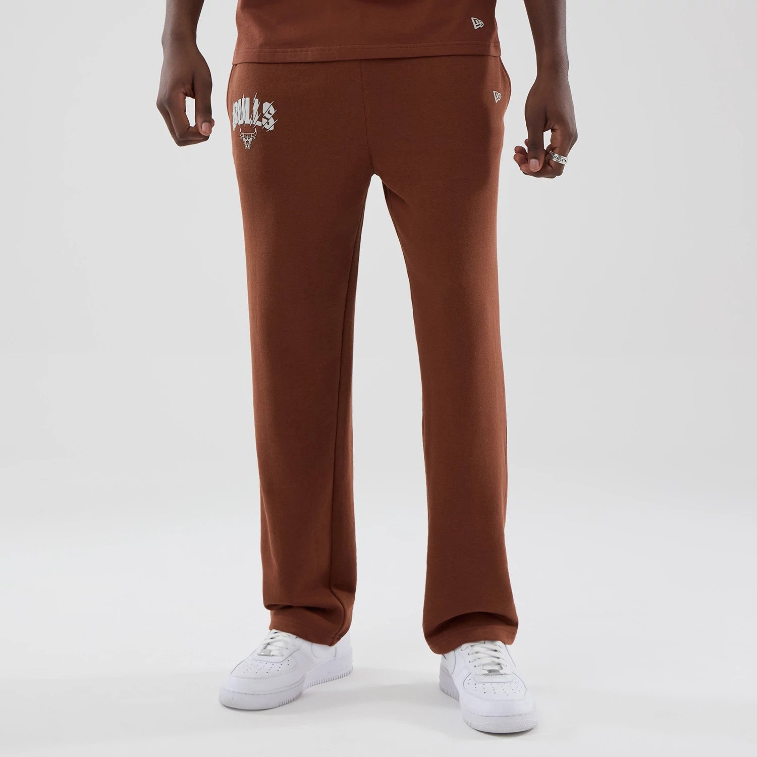 The model is wearing these NBA Core Plus Chicago Bulls Straight Leg Joggers in brown. 1