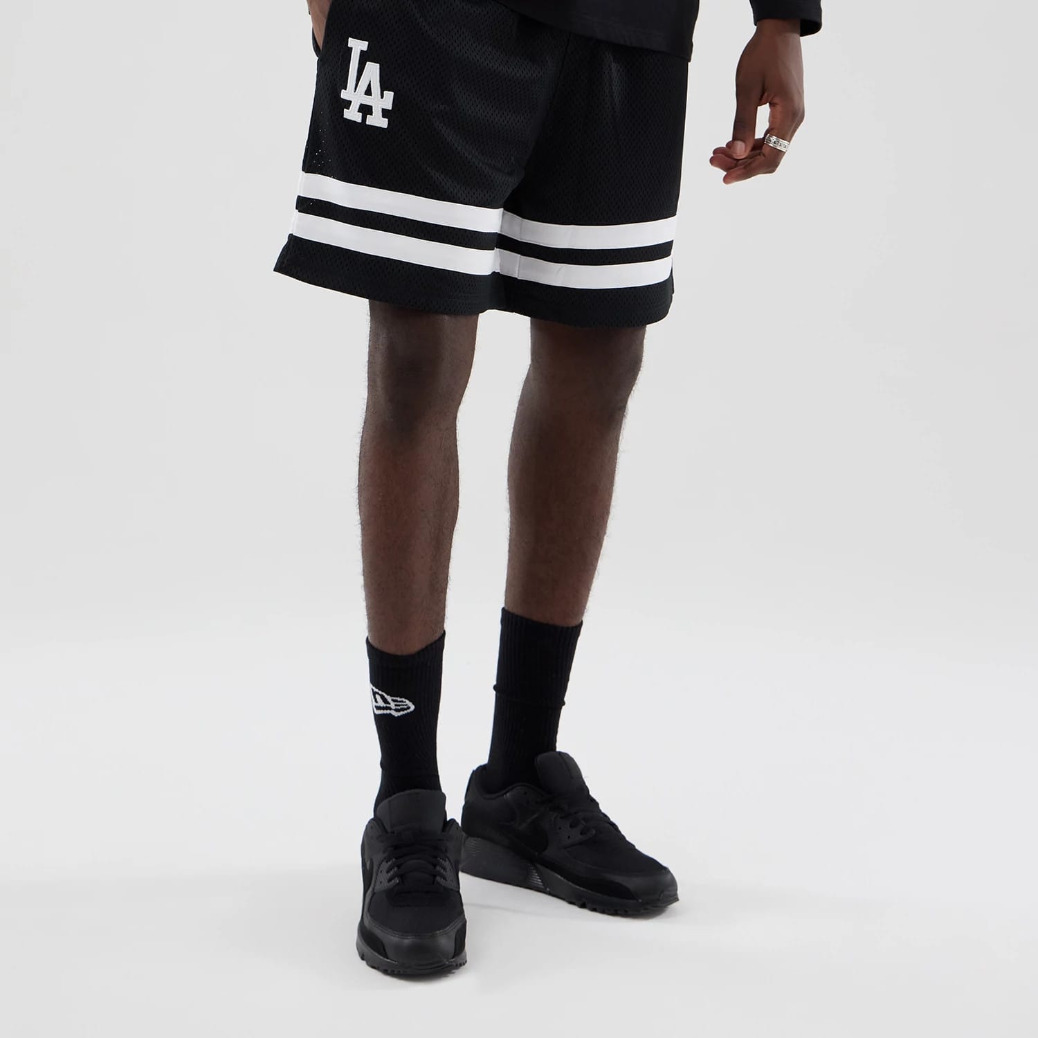 The model is wearing these MLB Mesh LA Dodgers Oversized Shorts in black. 1