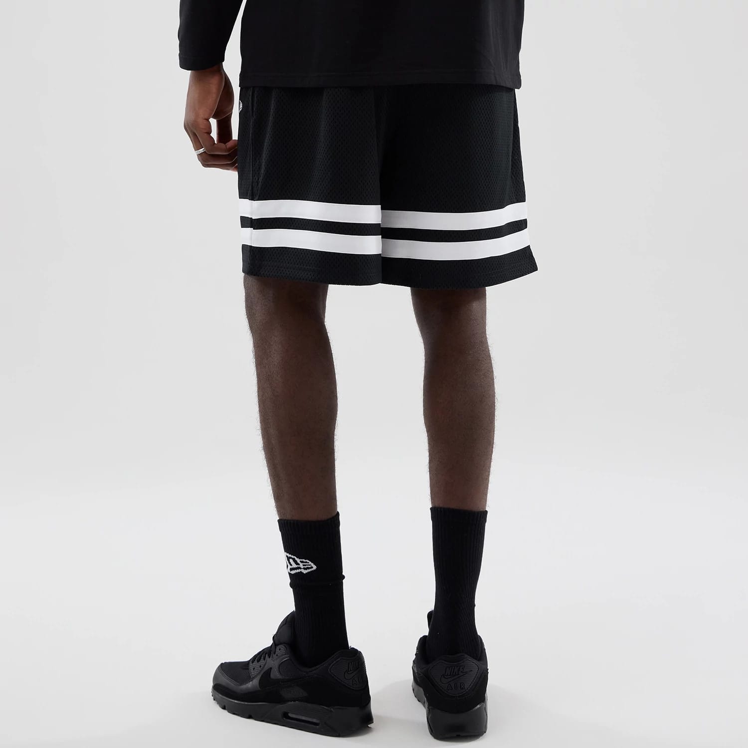 The model is wearing these MLB Mesh LA Dodgers Oversized Shorts in black. 2