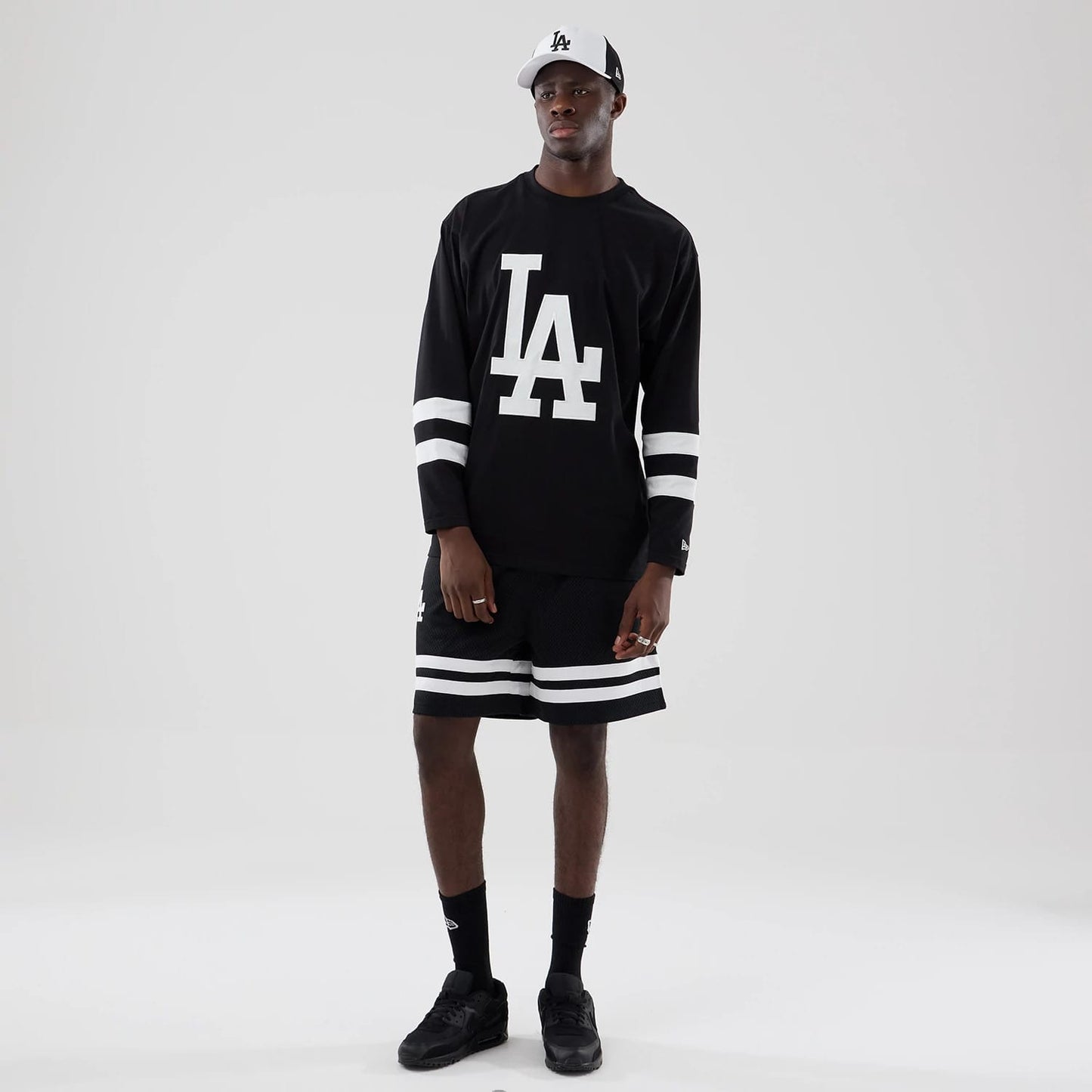 The model is wearing these MLB Mesh LA Dodgers Oversized Shorts in black. 8
