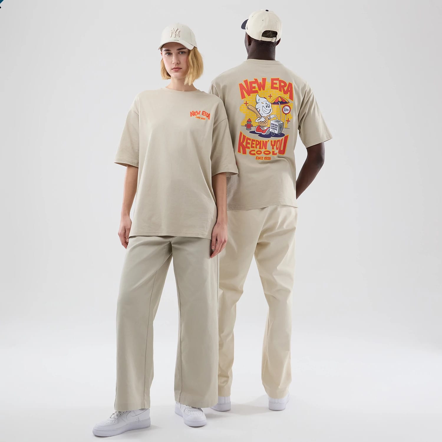 The model is wearing this New Era Food Graphic Oversized T-Shirt in light beige. 1