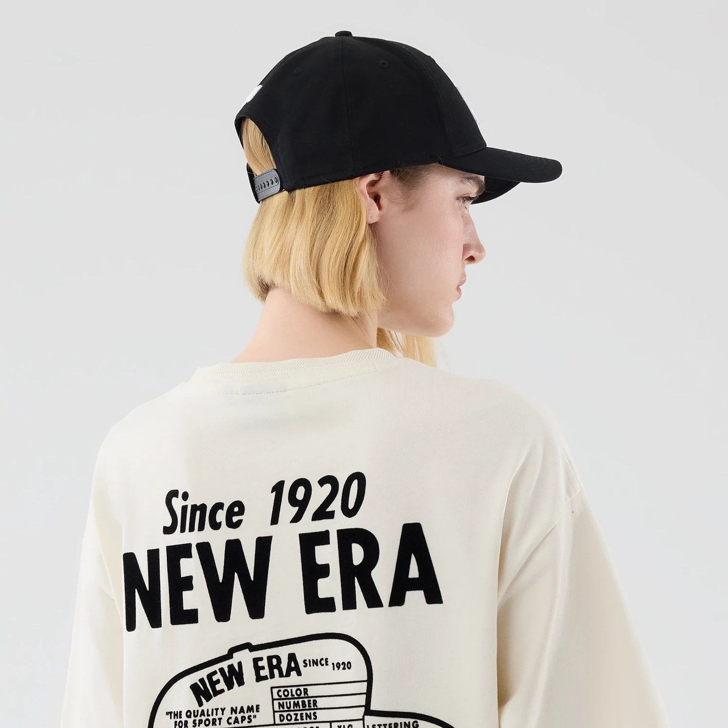 The model is wearing this New Era Cap Graphic Oversized T-Shirt in cream. 8