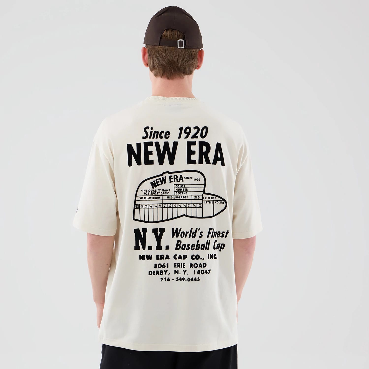 The model is wearing this New Era Cap Graphic Oversized T-Shirt in cream. 2
