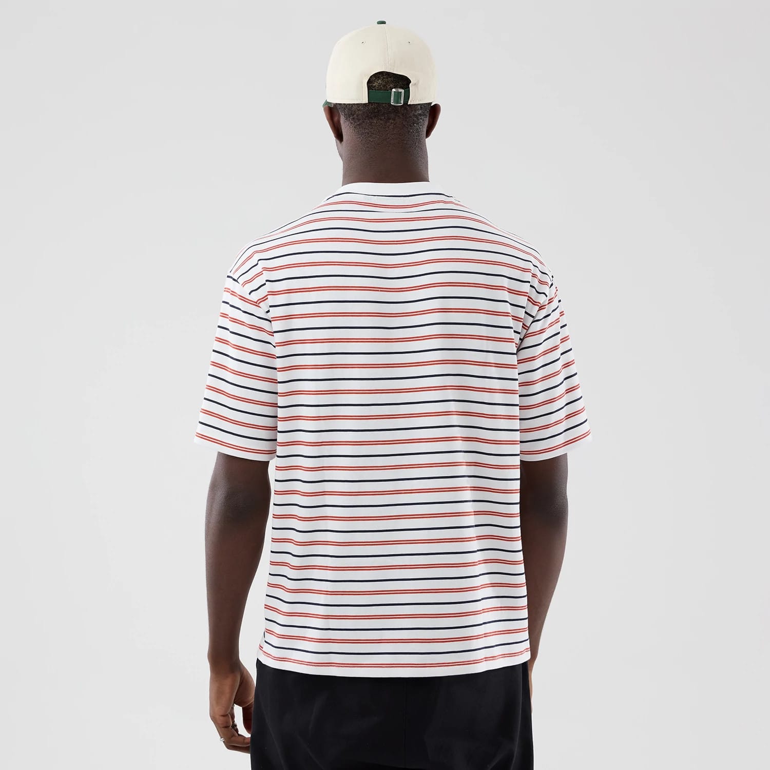 The model is wearing this New Era Stripe Oversized T-Shirt in white. 2
