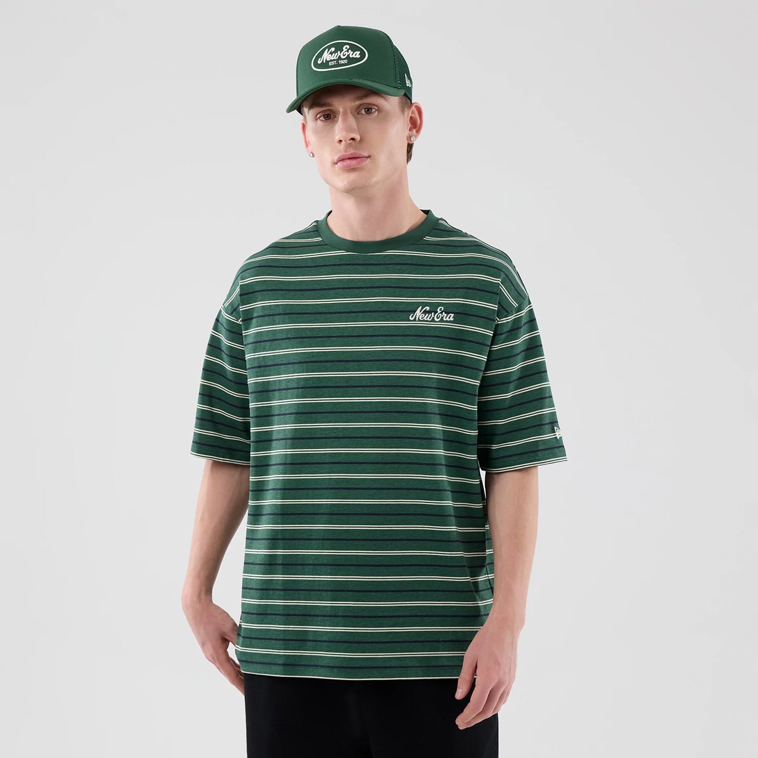 The model is wearing this New Era Stripe Oversized T-Shirt in dark green. 3