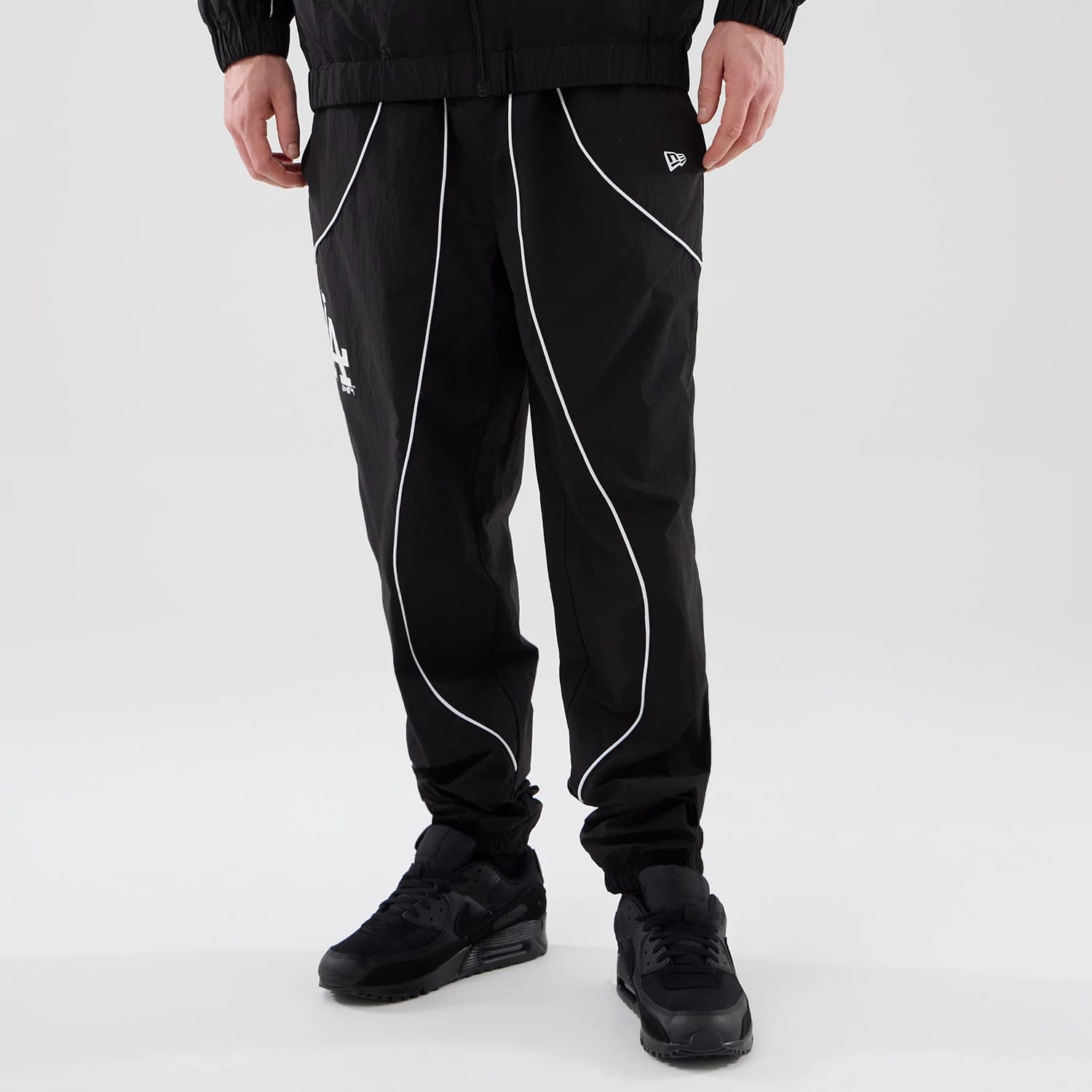 The model is wearing these MLB Piping Track LA Dodgers Track Pants in black. 1
