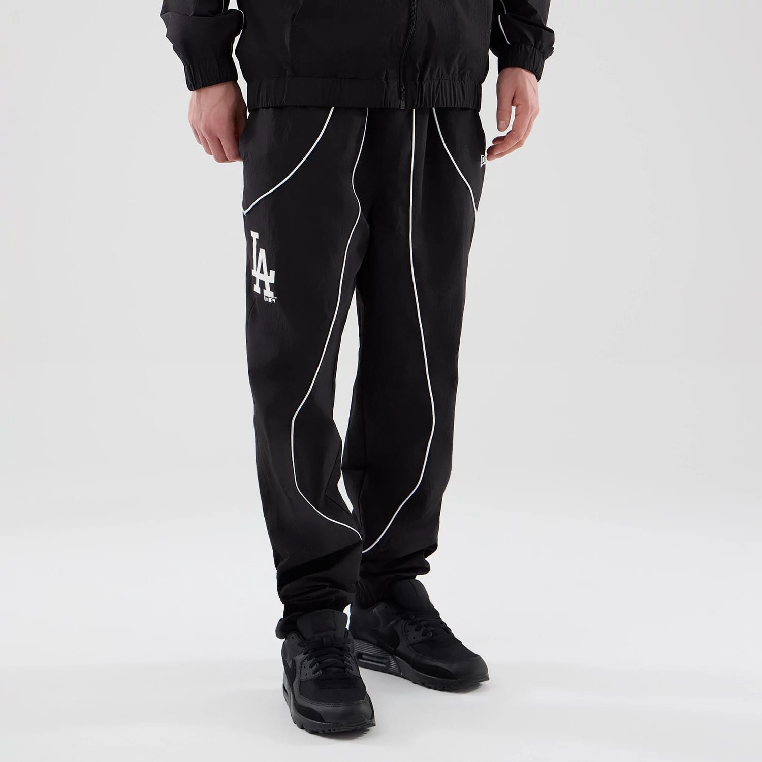 The model is wearing these MLB Piping Track LA Dodgers Track Pants in black. 3