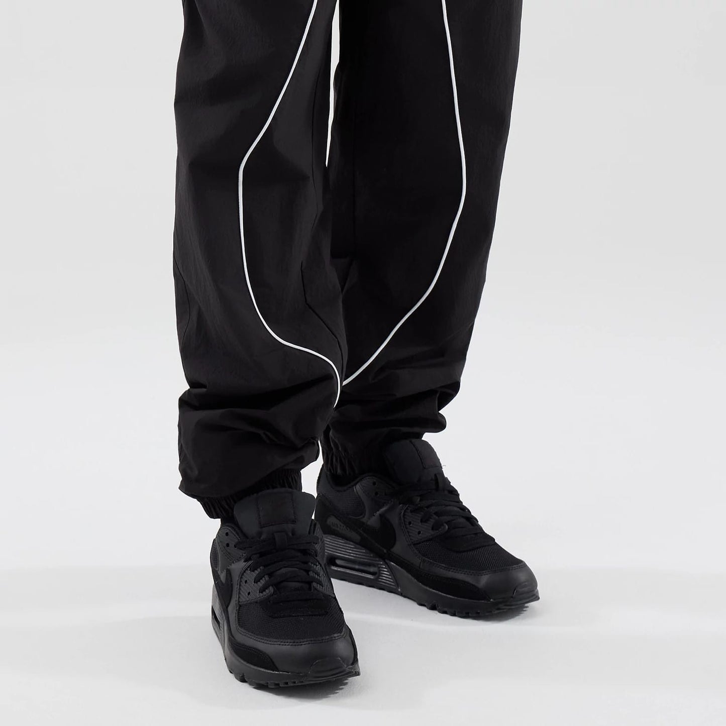 The model is wearing these MLB Piping Track LA Dodgers Track Pants in black. 7
