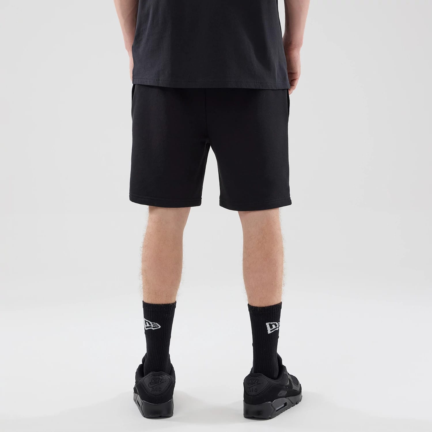 The model is wearing these NBA League Essential Chicago Bulls Oversized Shorts in black. 2
