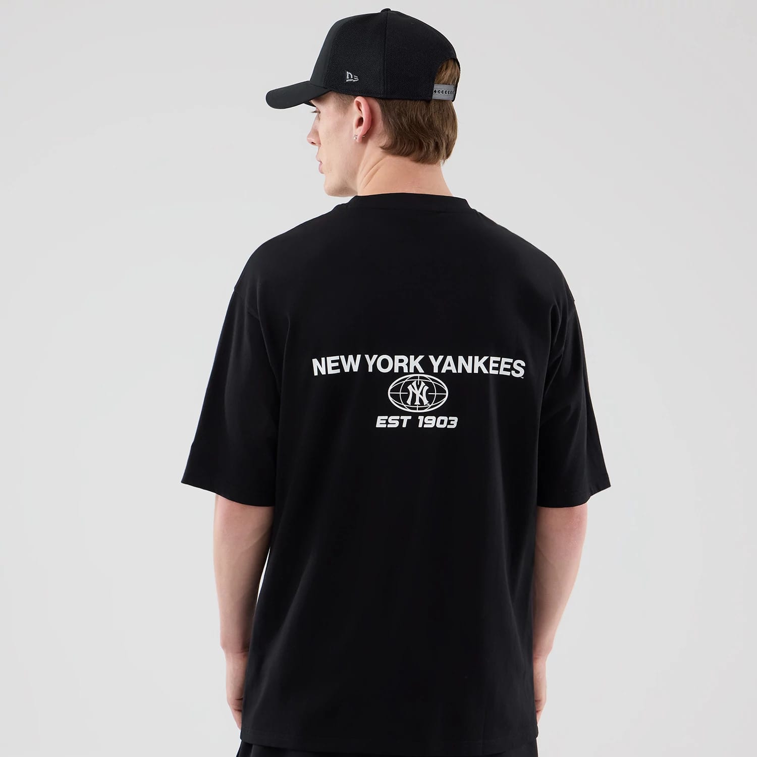The model is wearing this MLB Logo Graphic New York Yankees Oversized T-Shirt in black. 2