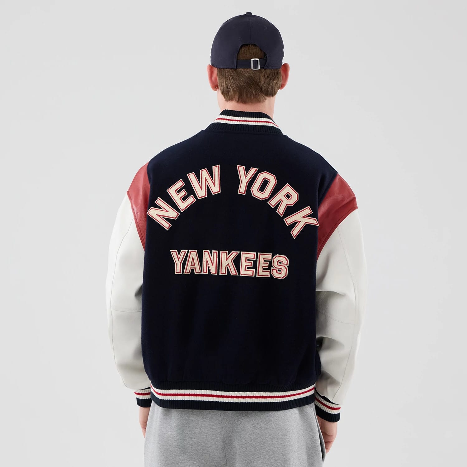 The model is wearing this MLB Varsity New York Yankees Jacket in navy. 2