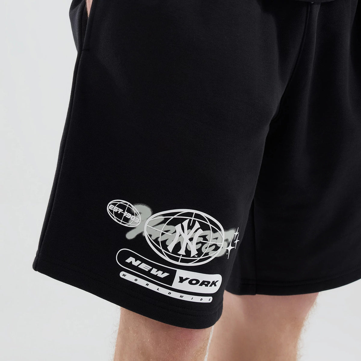 New Era New York Yankees MLB Logo Graphic Black Oversized Shorts, three-quarter view of a model wearing the black shorts featuring a white printed Yankees logo inside a globe graphic on the lower leg.