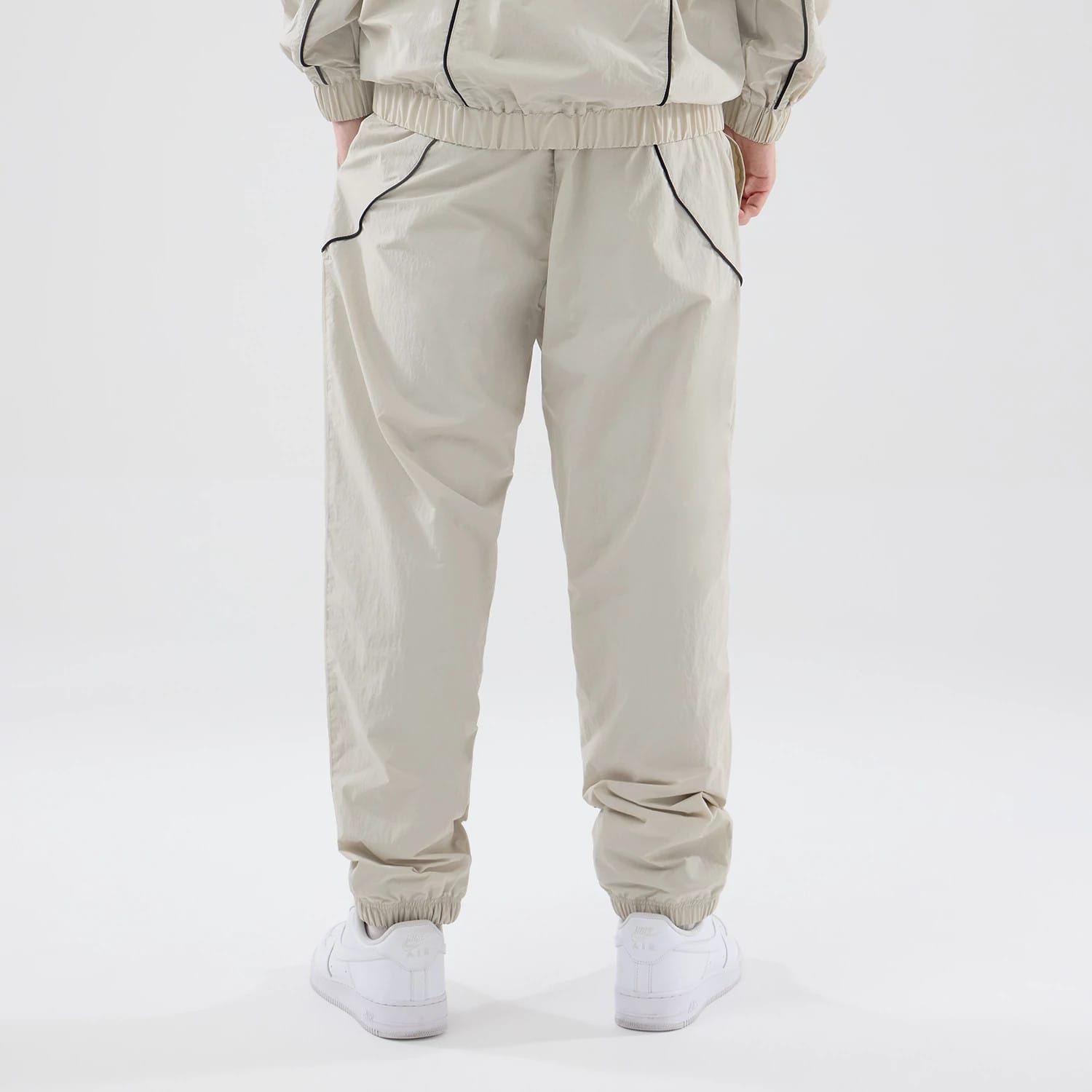 The model is wearing these MLB Piping Track New York Yankees Track Pants in cream. 2