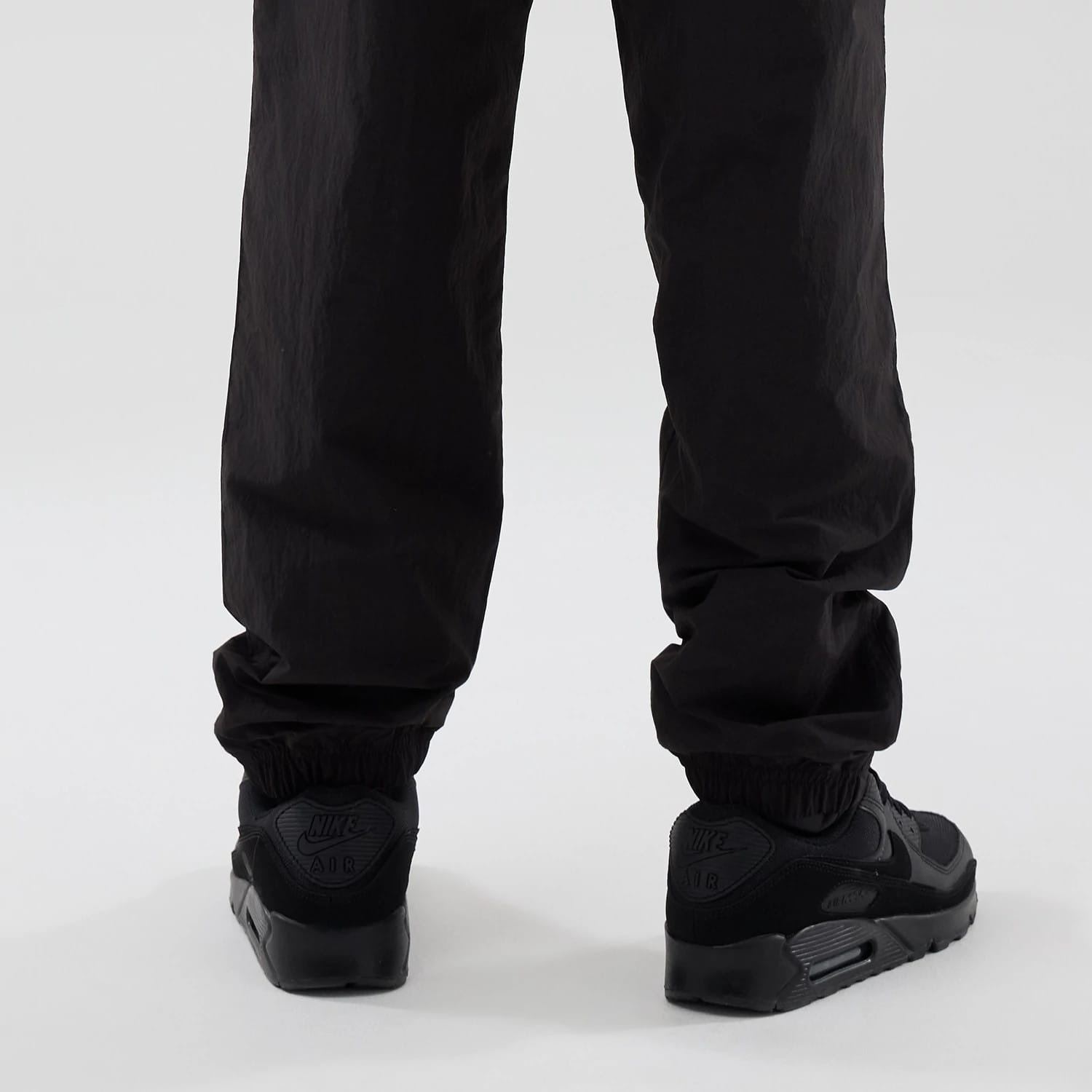 The model is wearing these Red Bull Racing Piping Track Pants in black. 3