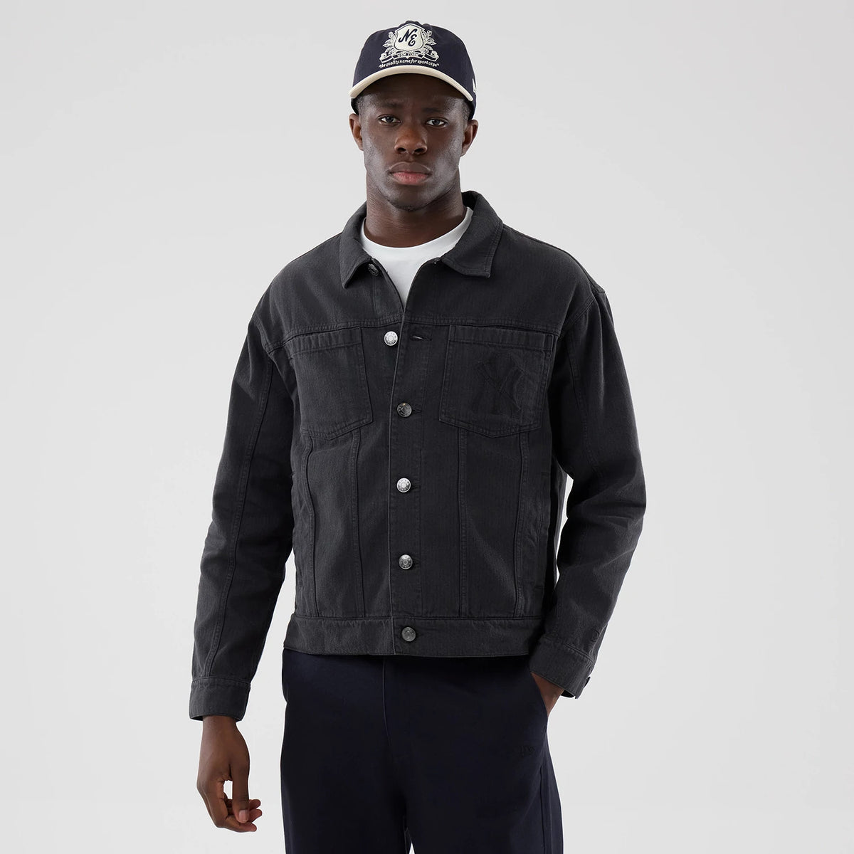 New Era New York Yankees MLB Stripe Denim Grey Jacket, front view on-model showing the classic collared denim jacket with button closure, debossed Yankees logo on the chest pocket and styled with a coordinating New Era cap and dark trousers.