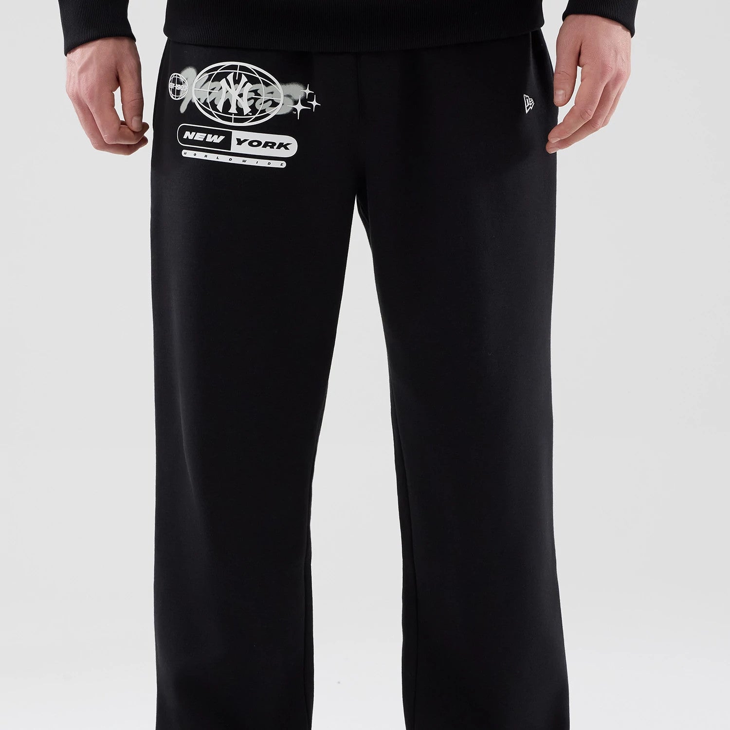 The model is wearing these MLB Logo Graphic New York Yankees Straight Leg Joggers in black. 3