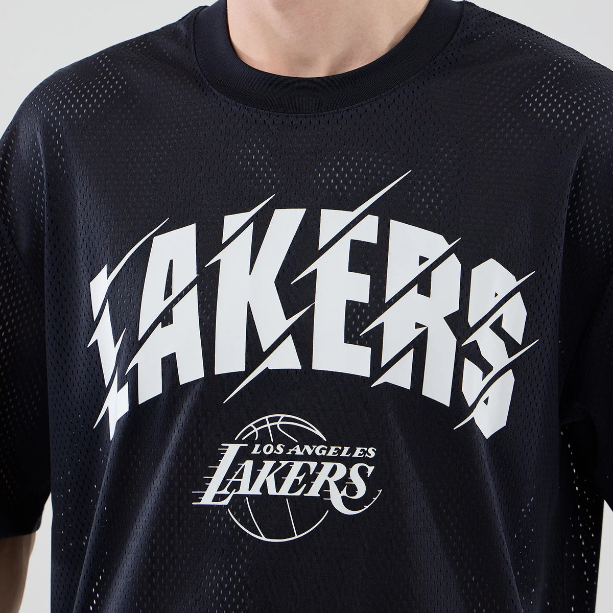 New Era LA Lakers NBA Core Plus Mesh Navy Oversized T-Shirt, front view featuring white printed LAKERS text in a font across the chest, with the Los Angeles Lakers logo below, all set on a dark navy mesh fabric.