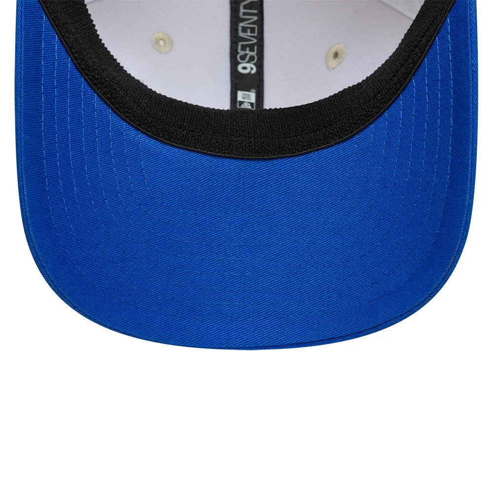 Alpine Racing Contrast Visor Cream New Era 9SEVENTY Stretch Snap Adjustable Cap, inside view showing the black sweatband, white taping bearing the 9SEVENTY logo, and blue undervisor with detailed stitching around the edge.