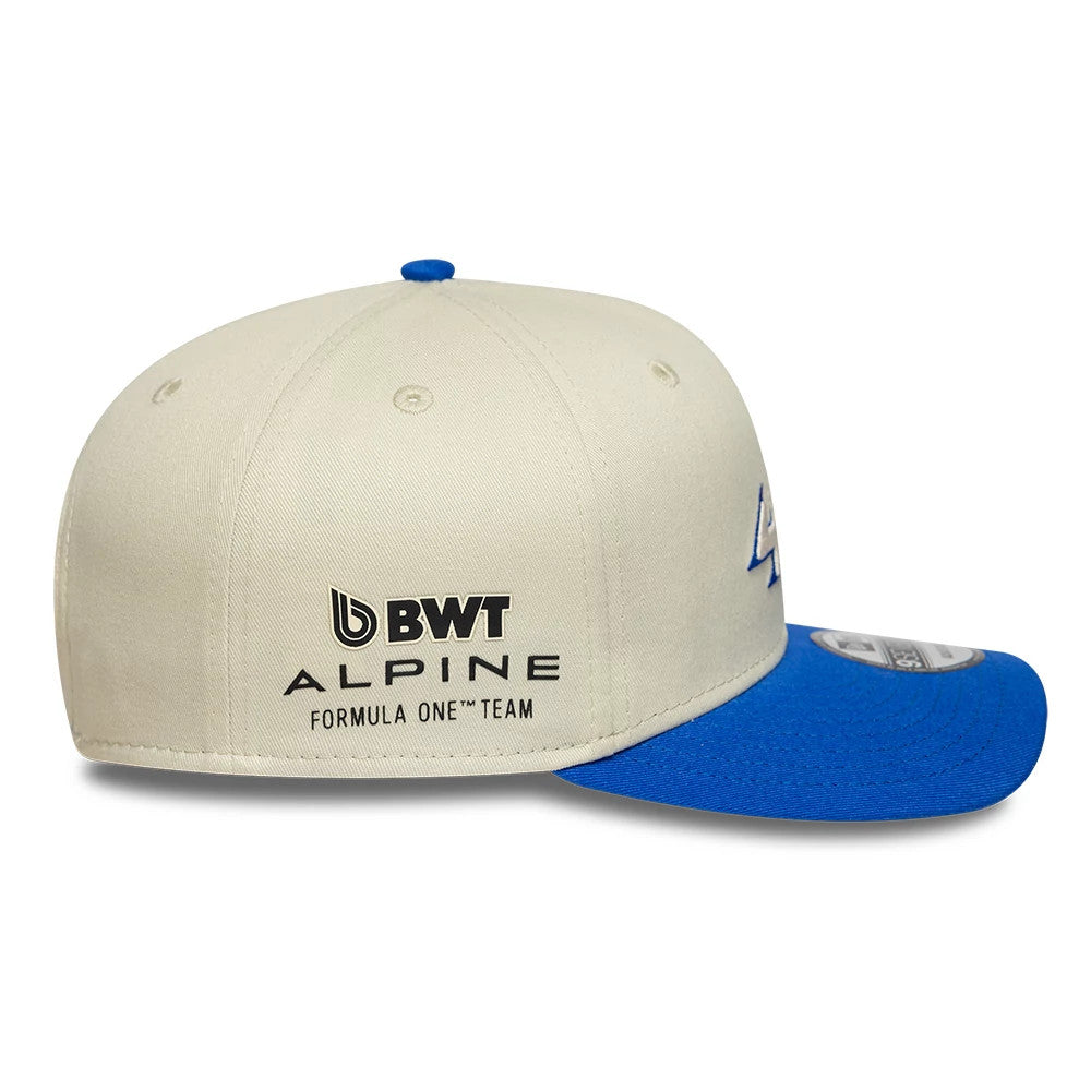 Alpine Racing Contrast Visor Cream New Era 9SEVENTY Stretch Snap Adjustable Cap, side view showing the embroidered BWT Alpine Formula One Team logo on the cream crown, with a bright blue visor and matching top button.