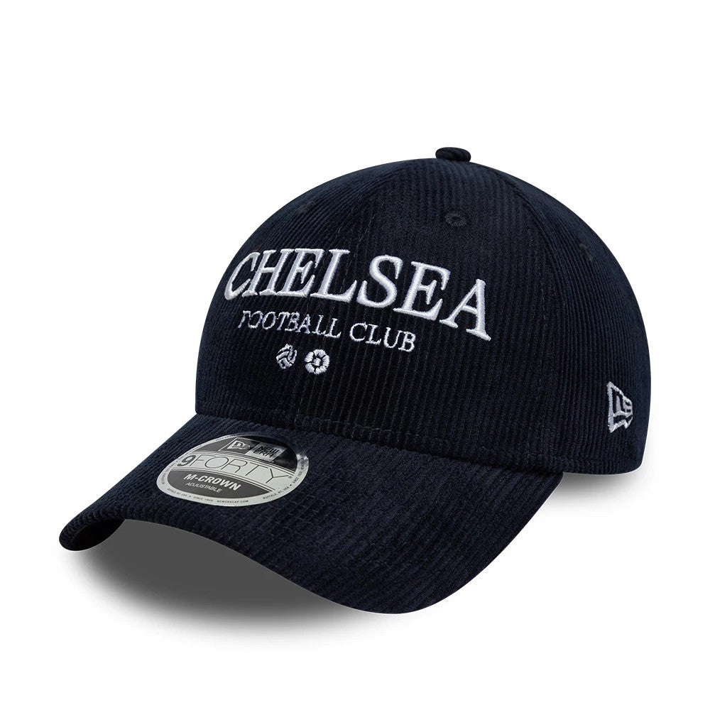 Chelsea FC Cord Navy New Era 9FORTY M-Crown Adjustable Cap, front view showing the white embroidered Chelsea FC wordmark on the structured navy corduroy crown, with a curved visor, eyelets, and a 9FORTY size sticker on the upper visor.