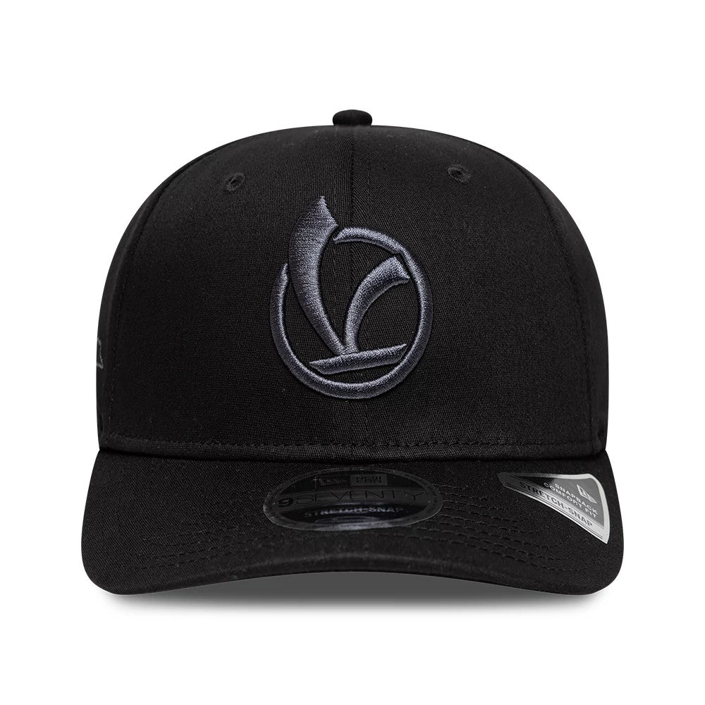 Vespa Black New Era 9SEVENTY Stretch Snap Adjustable Cap, front view showing a grey embroidered Vespa logo on the black front panel with a curved visor, black 9SEVENTY size sticker centred on the visor.
