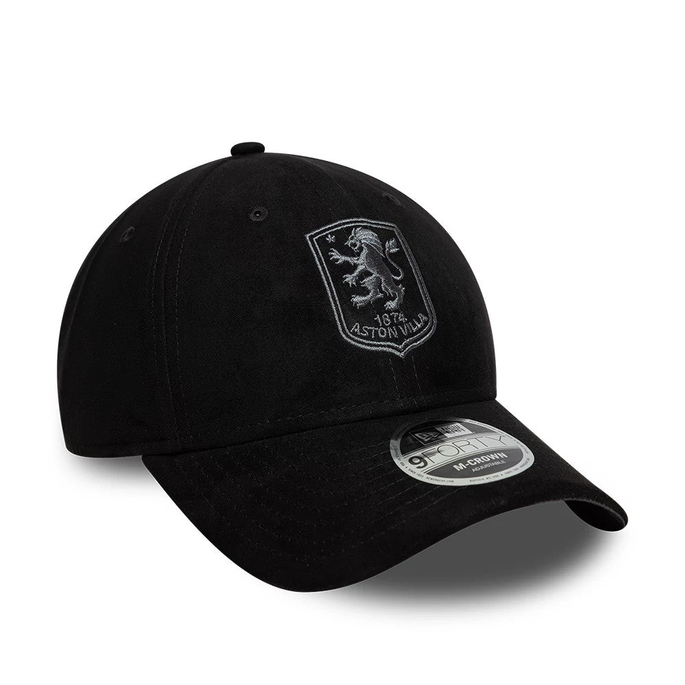 Aston Villa FC Faux Suede Black New Era 9FORTY M-Crown Adjustable Cap, three-quarter view showing the white Aston Villa crest in raised embroidery on the front panel, with a black curved visor and a 9FORTY size sticker on the top.