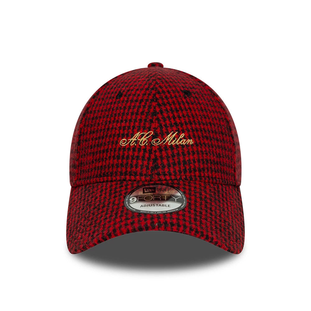 AC Milan Houndstooth Red New Era 9FORTY Adjustable Cap, front view showing the gold embroidered A.C. Milan script on the red and black houndstooth patterned crown, with a curved visor and a 9FORTY size sticker in the centre.