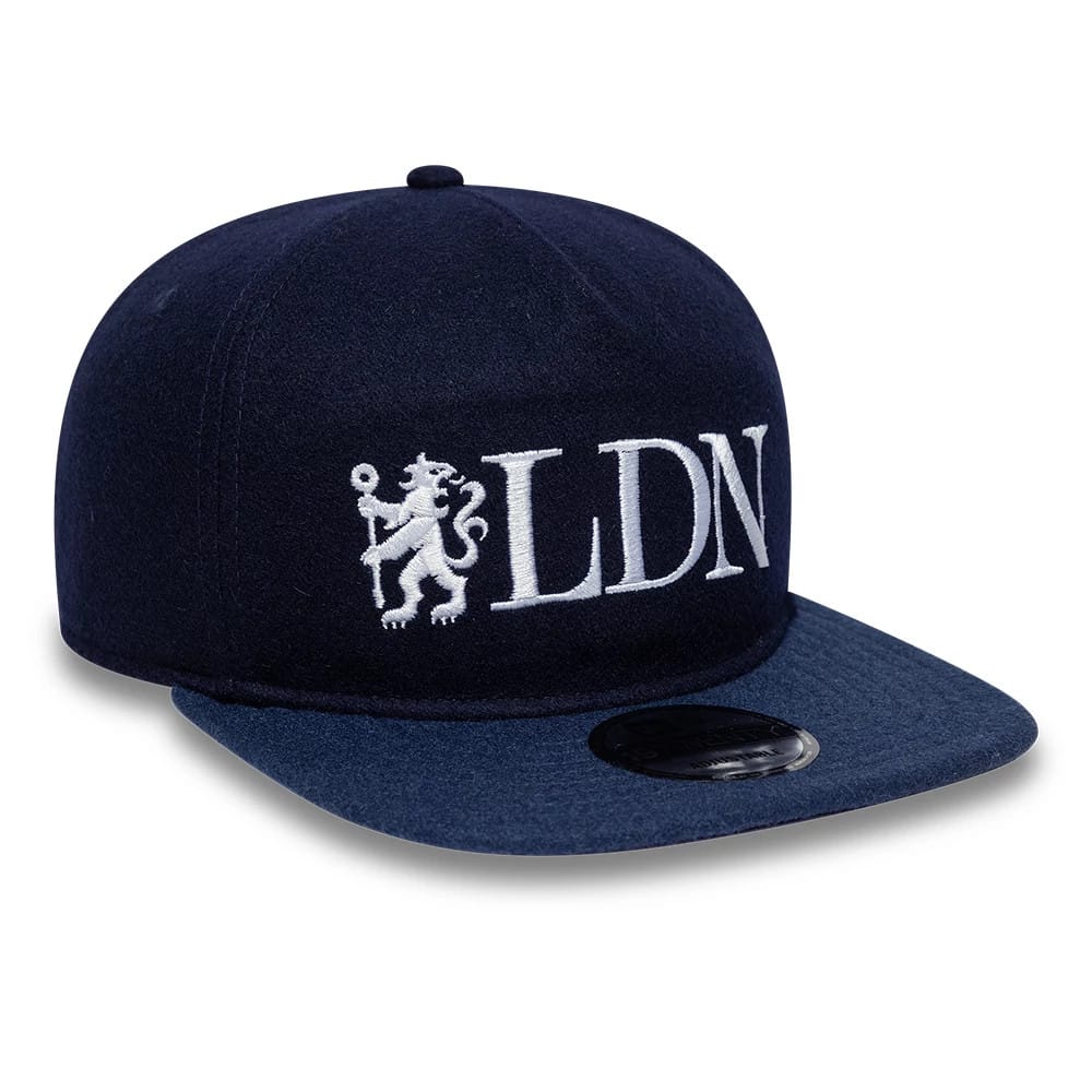 Chelsea FC London Wool Navy New Era 19TWENTY Adjustable Cap, three-quarter view showing the white embroidered LDN lion logo on the front panel, navy flat visor with a black size sticker, and a structured wool crown.