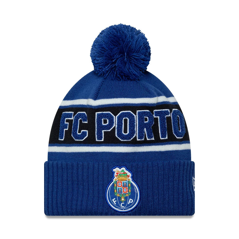 New Era FC Porto Blue Cuff Knit Beanie Hat, front view showing white and blue FC Porto lettering embroidered on the black band, a large blue pom-pom on top, and the FC Porto crest on the blue ribbed cuff.