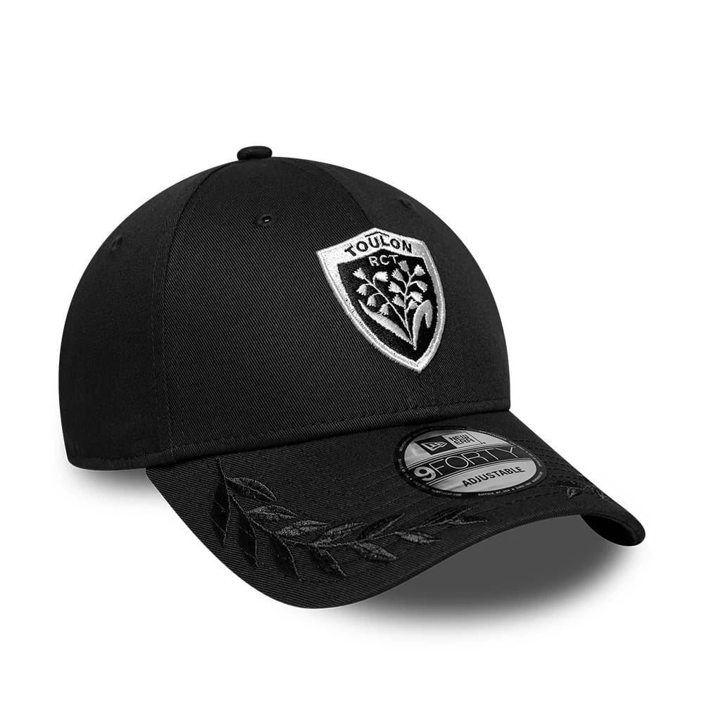 Rugby Club Toulon Cigales Black New Era 9FORTY Adjustable Cap, three-quarter view showing the white embroidered Toulon crest on the front panel, black visor with leaf embroidery, and a 9FORTY size sticker on the curved visor.