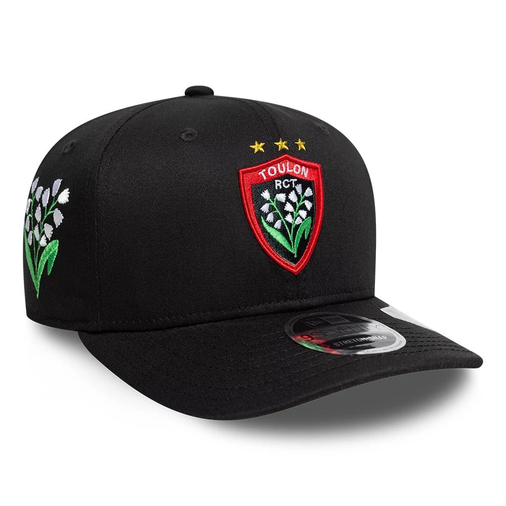 Rugby Club Toulon Lily Black New Era 9SEVENTY Stretch Snap Adjustable Cap, three-quarter view showing the raised embroidered Toulon RCT logo on the front panel, black curved visor with a size sticker, and lily embroidery on the side.