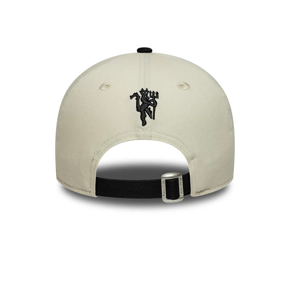 Manchester United FC Monogram Cream & Black New Era 9FORTY Adjustable Cap, rear view showing the black embroidered crest on the centre back of the cream crown, with a black adjustable strap featuring a silver buckle.